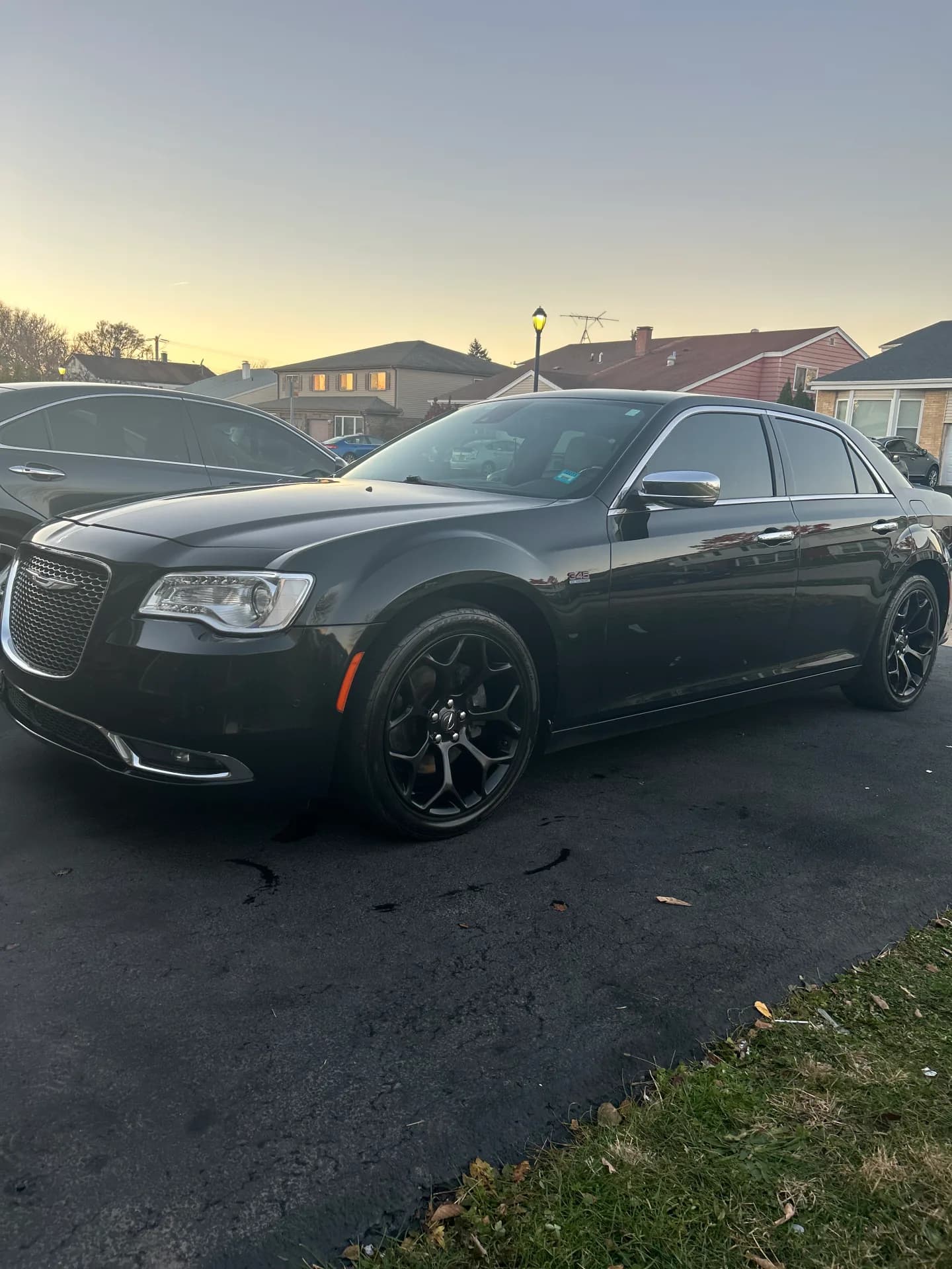 Black Chrysler 300 with deep gloss paint and freshly detailed black wheels