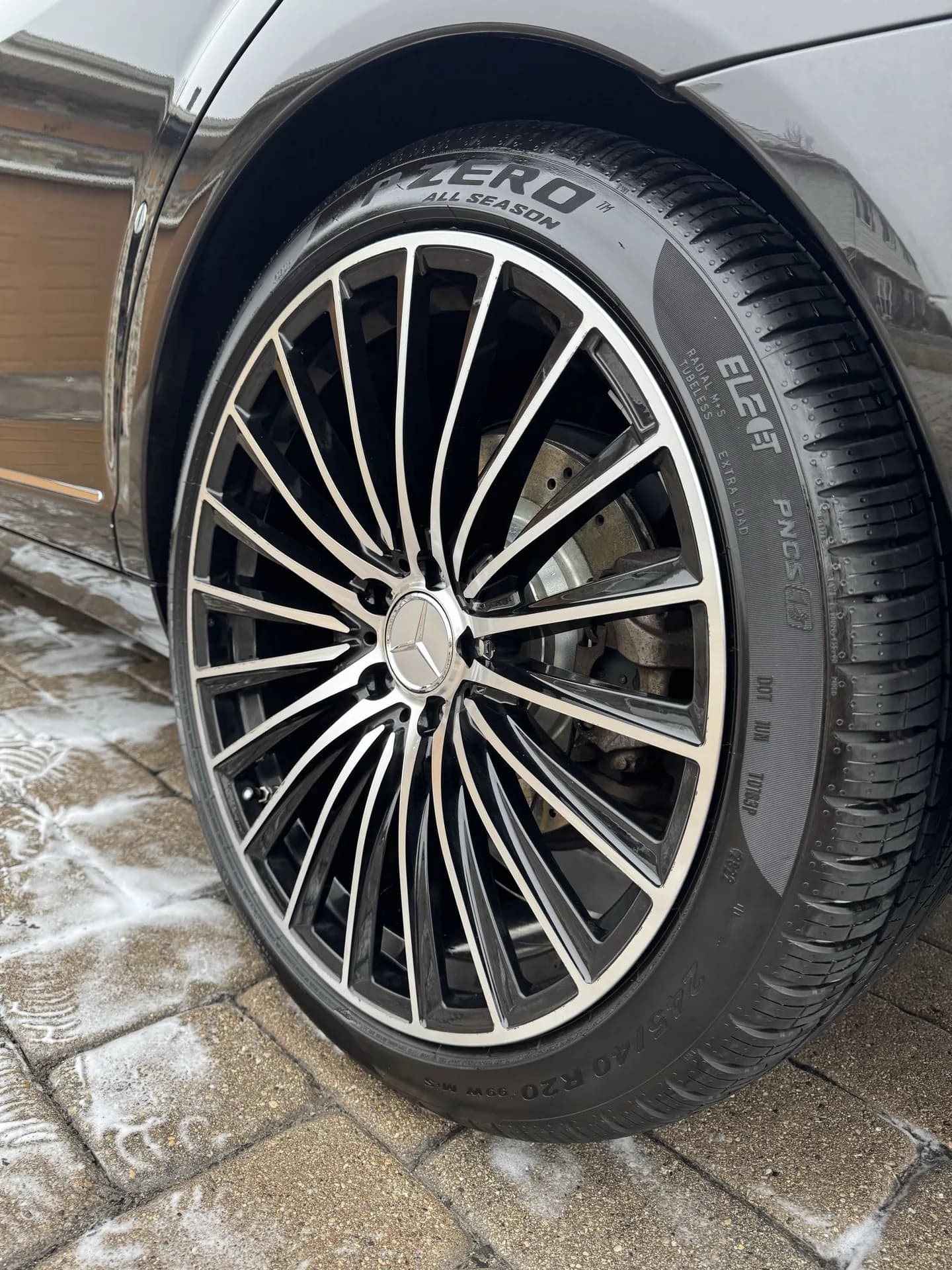 Close-up of a detailed Mercedes multi-spoke wheel with dressed tire