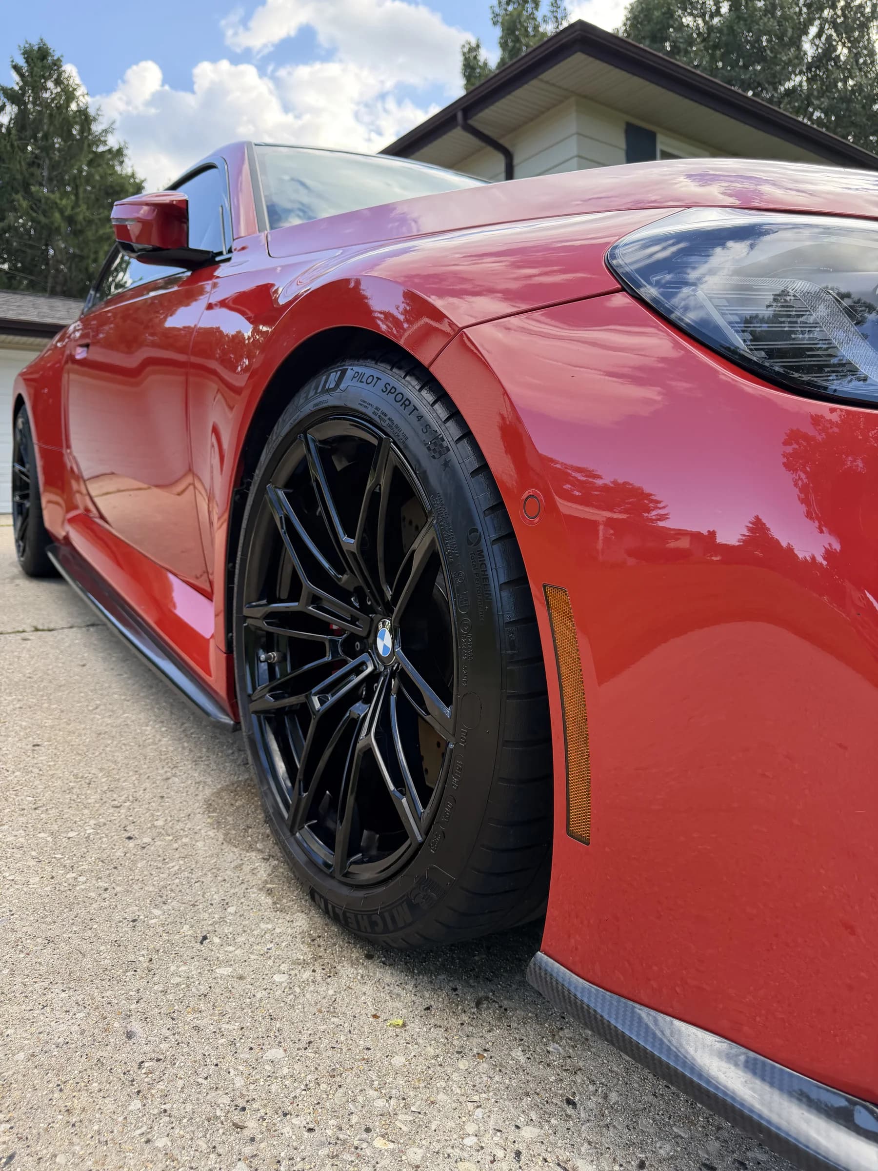 Red BMW M4 wheel after a wheel detail