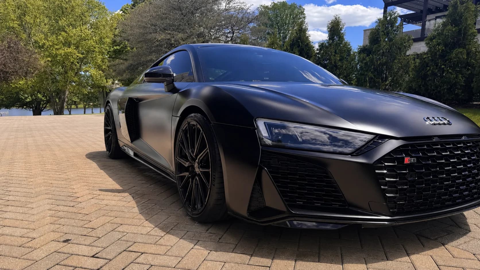 Matte black Audi R8 after a full exterior detail on a sunlit driveway